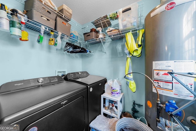 laundry room featuring washing machine and dryer, laundry area, a textured ceiling, and gas water heater