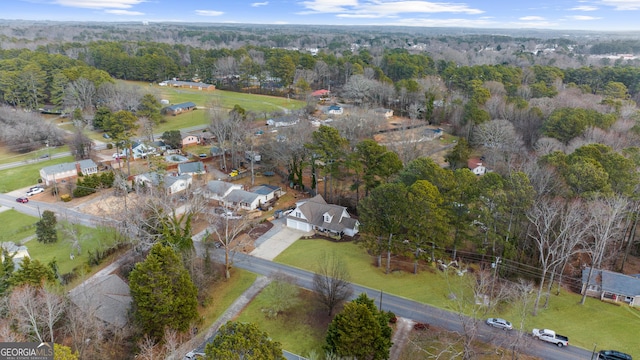 birds eye view of property featuring a forest view