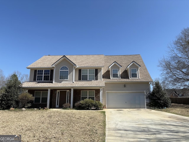 view of front of property featuring covered porch, driveway, roof with shingles, and an attached garage