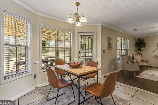 dining space with a chandelier, light tile patterned flooring, a wealth of natural light, and crown molding