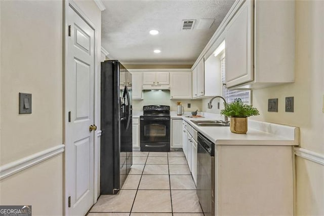 kitchen with white cabinets, under cabinet range hood, light countertops, black appliances, and a sink