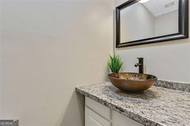 bathroom featuring visible vents and vanity