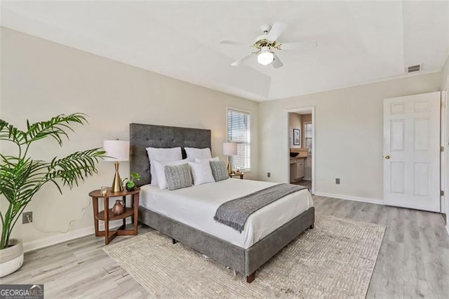 bedroom with light wood-type flooring, visible vents, and baseboards