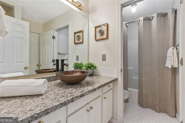 full bath with toilet, tile patterned floors, shower / bath combo with shower curtain, and vanity