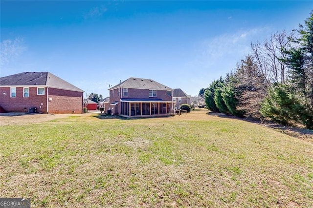 rear view of house with a yard