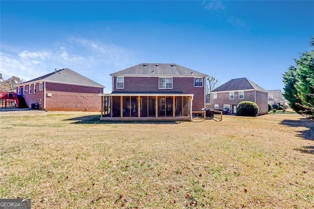 back of property with a yard and a sunroom