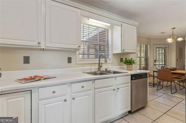 kitchen with a sink, white cabinetry, light countertops, stainless steel dishwasher, and pendant lighting