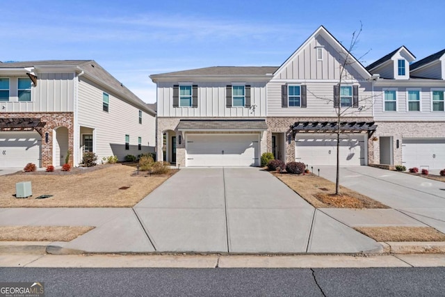 multi unit property with a garage, board and batten siding, and concrete driveway