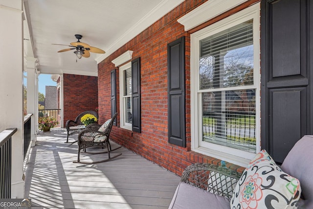 deck with a porch and a ceiling fan