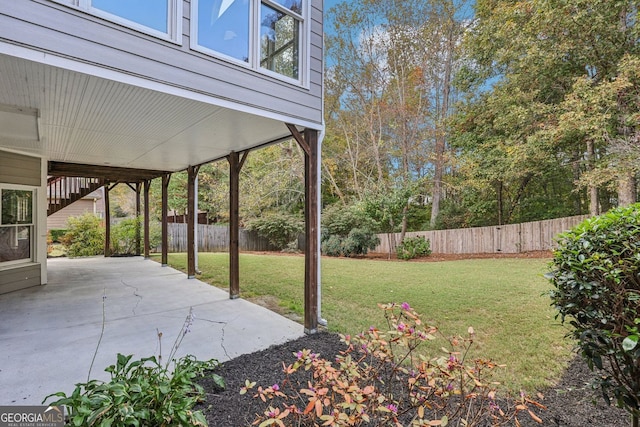 view of yard featuring fence and a patio