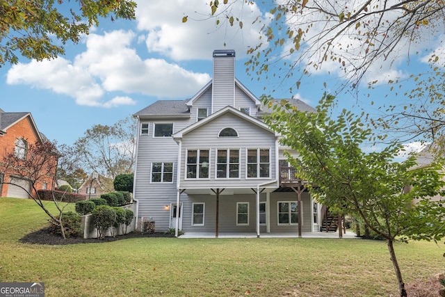 back of house with a yard, a patio, a chimney, and stairs