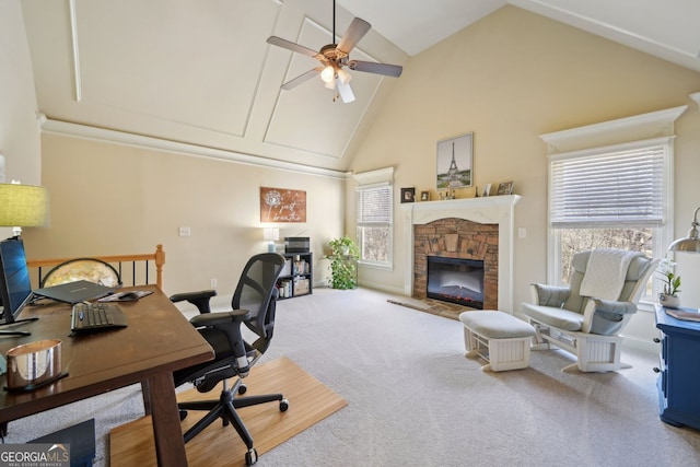 carpeted home office featuring ceiling fan, high vaulted ceiling, and a stone fireplace