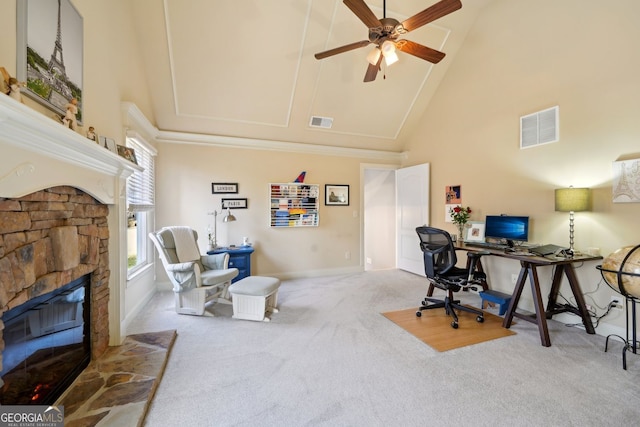 carpeted home office featuring high vaulted ceiling, a fireplace, visible vents, and a ceiling fan