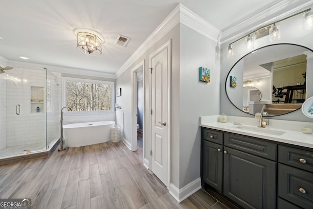 bathroom featuring a stall shower, vanity, visible vents, and crown molding