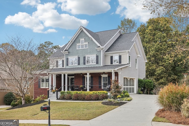 view of front of house featuring brick siding, covered porch, a front yard, a garage, and driveway