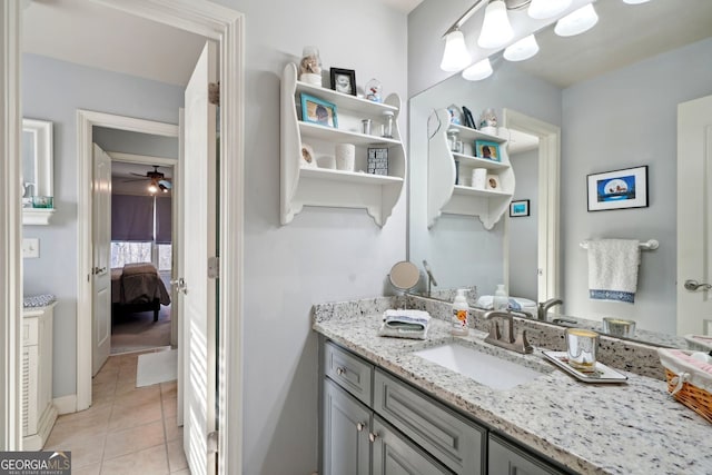 bathroom featuring connected bathroom, vanity, baseboards, and tile patterned floors