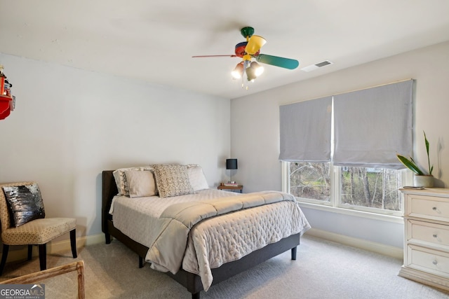 bedroom featuring light carpet, a ceiling fan, visible vents, and baseboards