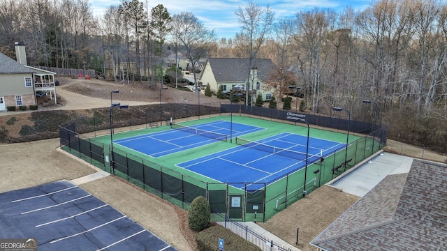 view of tennis court featuring fence