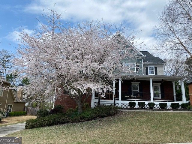 view of front of property with covered porch and a front yard