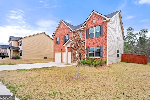 traditional home featuring concrete driveway, brick siding, a front yard, and fence