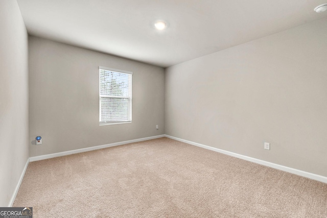 carpeted spare room with baseboards