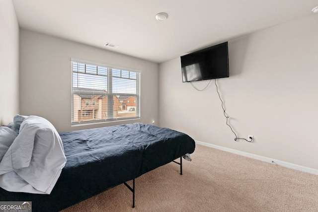 carpeted bedroom with visible vents and baseboards