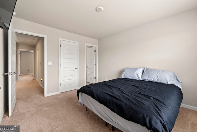 bedroom with light colored carpet and baseboards