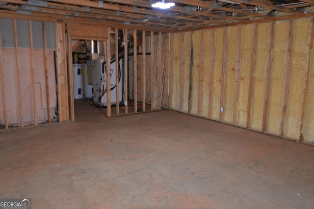 basement featuring electric water heater and heating unit