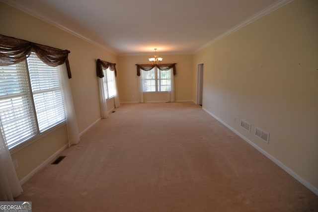 spare room featuring a chandelier, crown molding, visible vents, and light colored carpet