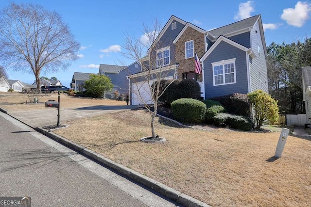 traditional home featuring driveway, a garage, and a residential view