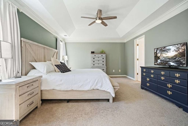 bedroom with light carpet, a ceiling fan, baseboards, ornamental molding, and a raised ceiling