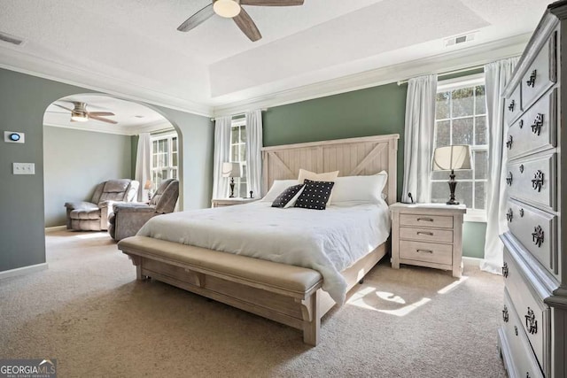 bedroom with light carpet, baseboards, arched walkways, and crown molding