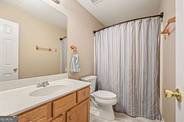 bathroom with visible vents, toilet, curtained shower, a textured ceiling, and vanity