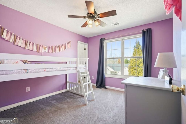 bedroom featuring visible vents, light carpet, ceiling fan, a textured ceiling, and baseboards