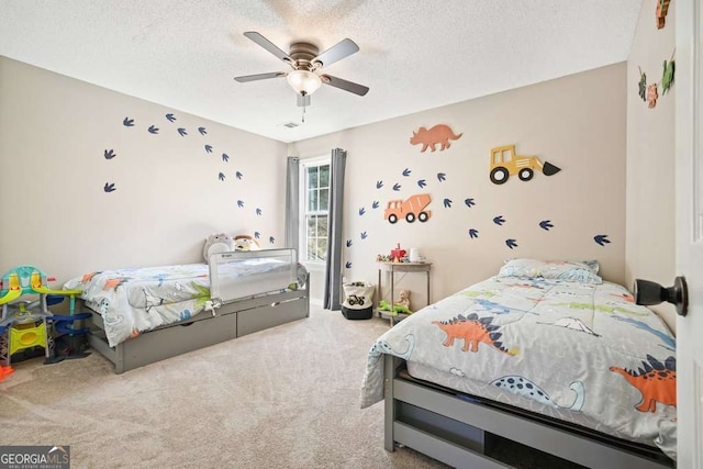 bedroom featuring a textured ceiling, carpet floors, and a ceiling fan