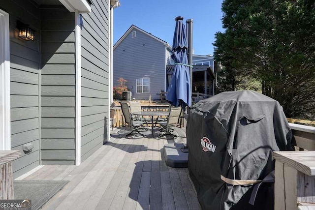 deck with outdoor dining area and area for grilling