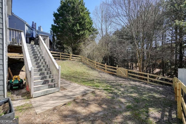 view of yard featuring a fenced backyard and stairs