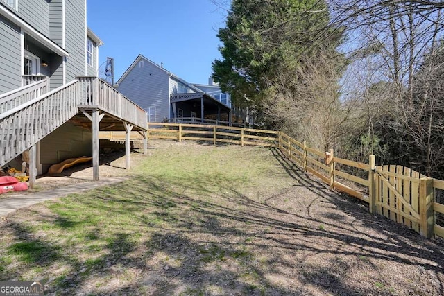 view of yard featuring stairs and a fenced backyard