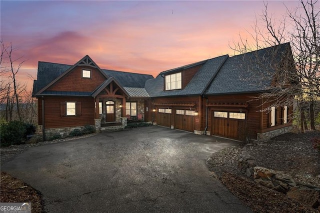 view of front of house with aphalt driveway and a garage