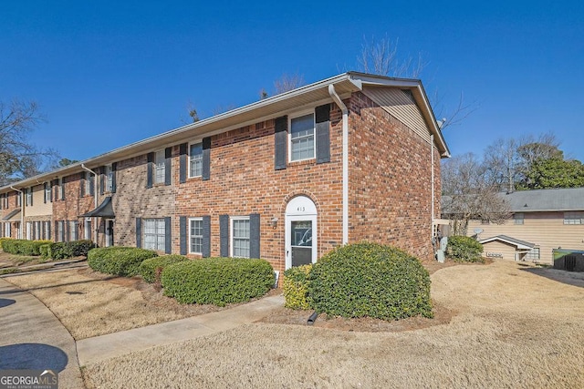 townhome / multi-family property featuring brick siding and central AC unit