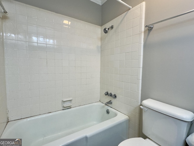 bathroom featuring tub / shower combination and toilet