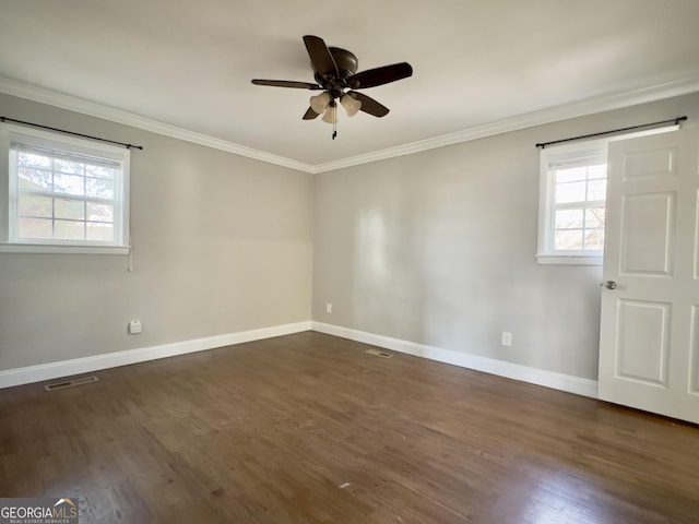 spare room with visible vents, dark wood-type flooring, and crown molding