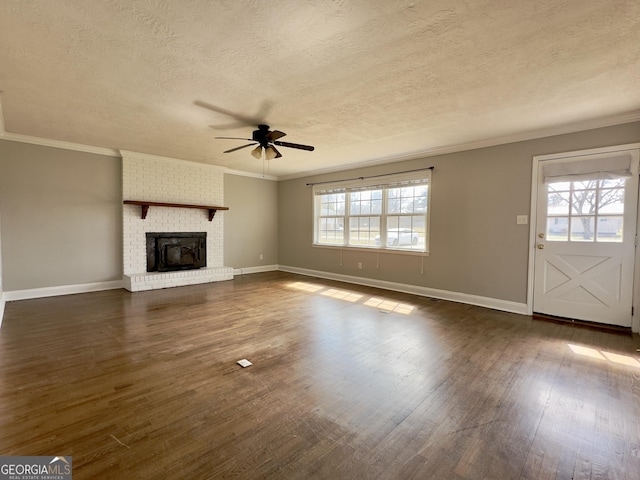 unfurnished living room with dark wood-style flooring, a fireplace, and crown molding