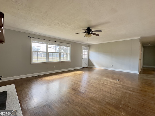 unfurnished living room with dark wood-style floors, a ceiling fan, ornamental molding, and a textured ceiling