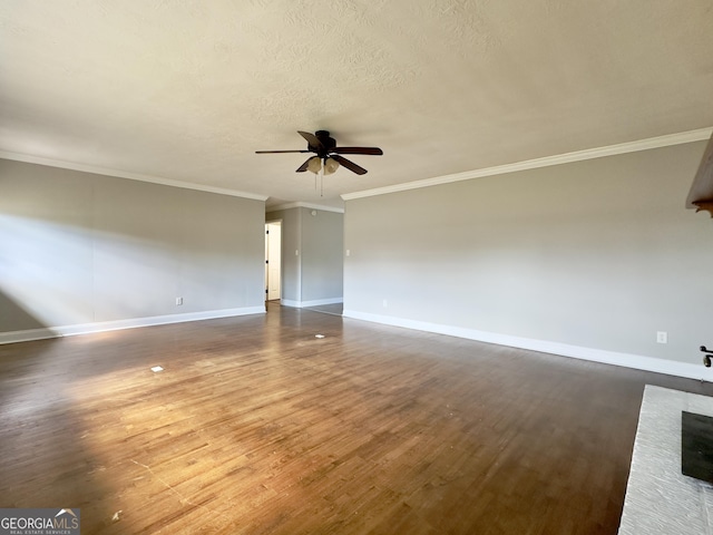 empty room featuring dark wood-style floors, a textured ceiling, a ceiling fan, and baseboards