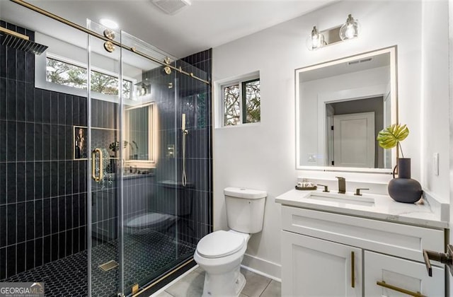 bathroom featuring a stall shower, visible vents, a healthy amount of sunlight, and vanity