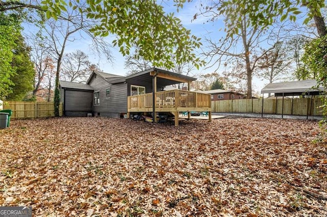 rear view of property with crawl space, fence, and a deck