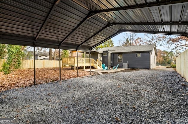 view of parking featuring a carport and fence