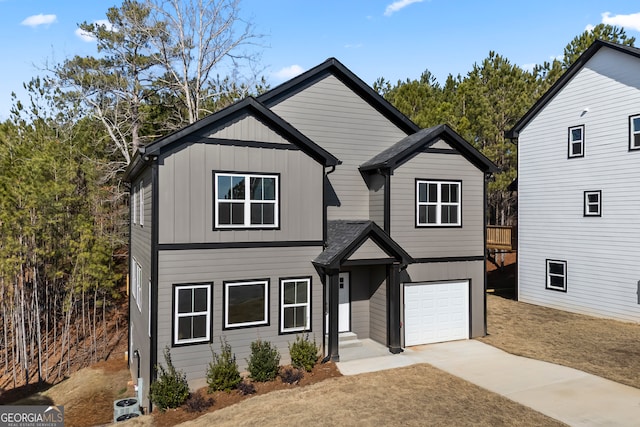 view of front of home featuring board and batten siding, cooling unit, concrete driveway, and an attached garage