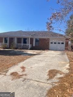 ranch-style house with a garage and driveway